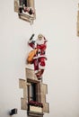 Decorative Santa Claus figure hanging from a facade