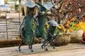 Decorative sculpture `Family of cucumbers` made of metal on a wooden table.