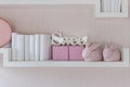 Decorative shelf on pink wall with rabbits ceramic and word Royalty Free Stock Photo
