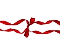 Decorative silk red ribbon with a bow on isolated white background. Cut out. Royalty Free Stock Photo