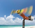 Decorative, small, colorful toy model of an airplane with propeller on pole on the sandy seashore