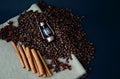 Decorative small lantern on coffee bean, canvas napkin on a dark background