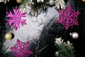 Decorative snowflake white and pink on black background. Christmas greeting card. Copy space. Top view. Royalty Free Stock Photo