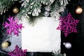 Decorative snowflake white and pink on black background. Christmas greeting card. Copy space. Top view. Royalty Free Stock Photo