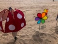 Decorative wind spinners on sandy beach Royalty Free Stock Photo