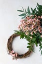 Decorative spring wreath made of twigs and flowers. DIY creativity