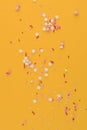 Decorative sprinkles star constellation on yellow background.