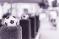 Decorative stand in form of the classic football ball in the net on the green grass. Ornaments of city streets, Blurred Royalty Free Stock Photo