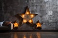 Decorative star with lamps on a background of wall. Modern grungy interior Royalty Free Stock Photo