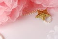 Decorative star, pearl beads and pink and white pom pom Royalty Free Stock Photo