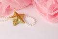 Decorative star, pearl beads and pink and white pom pom. Royalty Free Stock Photo