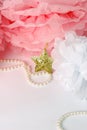 Decorative star, pearl beads and pink and white pom pom. Royalty Free Stock Photo