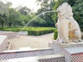 Decorative stone fountain in the shape of a lion spouting water in MarÃÂ­a Luisa Park in Seville Royalty Free Stock Photo