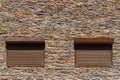 Decorative stone wall and window with roller shutters for background or texture Royalty Free Stock Photo