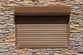 Decorative stone wall and window with roller shutters for background or texture Royalty Free Stock Photo