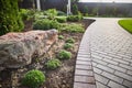 Decorative stones in the garden. tiled path in a beautiful park passes through a green lawn under soft sunlight Royalty Free Stock Photo