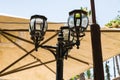 Decorative street metal lantern made in the old style stands on the main pedestrian HaMeyasdim street in Zikhron Yaakov city in Royalty Free Stock Photo