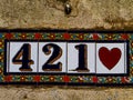 Decorative street number plate from facade of old house in Nimes, France Royalty Free Stock Photo