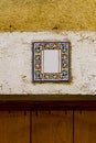 Decorative street number plate from facade of old house in Nimes, France Royalty Free Stock Photo
