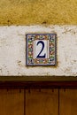 Decorative street number plate from facade of old house in Nimes, France Royalty Free Stock Photo