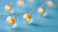 Decorative string lights with glowing yellow bulbs on a soft blue background Royalty Free Stock Photo