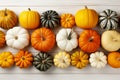 Decorative striped pumpkins on white wooden table. Thanksgiving decoration. Celebrating traditional autumn holidays. Top down view