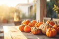 Decorative striped pumpkins on a wooden table on sunny autumn day. Thanksgiving decoration outdoors. Celebrating traditional