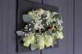 Decorative table arrangement featuring several wedding boutonnieres, accented with vibrant flowers Royalty Free Stock Photo