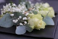 Decorative table arrangement featuring several wedding boutonnieres, accented with vibrant flowers Royalty Free Stock Photo