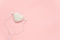 Decorative textile volume heart and white headphones on pink background. Concept Listen to your heart. Top view Copy space Flat Royalty Free Stock Photo