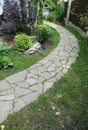 Path paved with a natural stone in a autumn garden. the inner yard is paved with decorative grey natural stone.