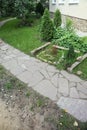 Path paved with a natural stone in a autumn garden. the inner yard is paved with decorative grey natural stone.