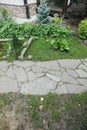 Path paved with a natural stone in a autumn garden. the inner yard is paved with decorative grey natural stone.