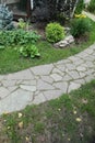 Path paved with a natural stone in a autumn garden. the inner yard is paved with decorative grey natural stone.