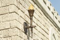 Decorative torch on stone castle wall Royalty Free Stock Photo