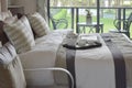 Decorative tray with book and tea set on the bed in modern bedroom Royalty Free Stock Photo