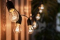 Decorative vintage edison light bulbs against striped wooden wall background. Royalty Free Stock Photo