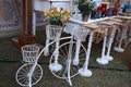 Decorative vintage old model bicycle with vases for flowers on a grassland, outdoor decorated background, wedding event