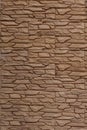 Decorative wall decoration with brick stone tiles, backdrop texture background. Wall in brown molded tile imitating masonry Royalty Free Stock Photo