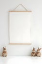 Decorative wall with empty frame and ceramic rabbits Royalty Free Stock Photo