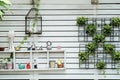 Decorative wall with shelf make from white wood in garden texture background