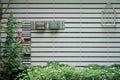 Decorative wall with shelf make from white wood in garden texture background