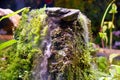 Decorative waterfall with green moss and grass on a slope Royalty Free Stock Photo