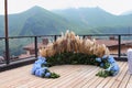 Decorative wedding arch made of fresh flowers on a picturesque terrace