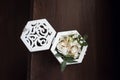 Decorative wedding box with gold wedding rings, decorated with flowers and grass Royalty Free Stock Photo