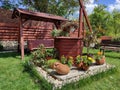 Decorative well with blossomed flower pots