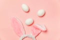 Decorative white eggs and bunny ears furry costume toy isolated on trendy pastel pink background Royalty Free Stock Photo