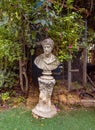 Decorative white stone bust of a man on exhibition in the Gardens Almona collection, in the rays of the setting sun, in the Druze