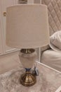 decorative white table lamp on sidetable