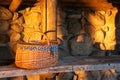 Decorative wicker basket on a wooden table against a stone wall background